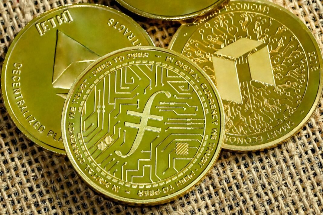 a pile of gold bitcoins sitting on top of a sack of burl