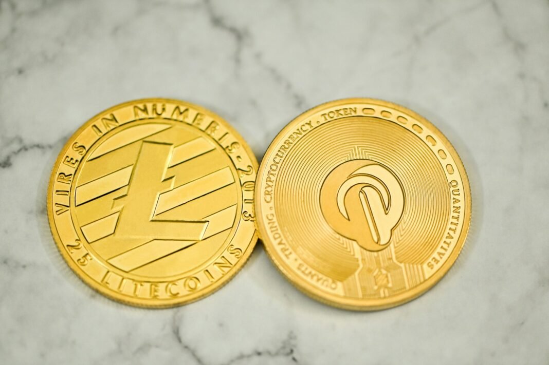 a close up of two gold coins on a marble surface